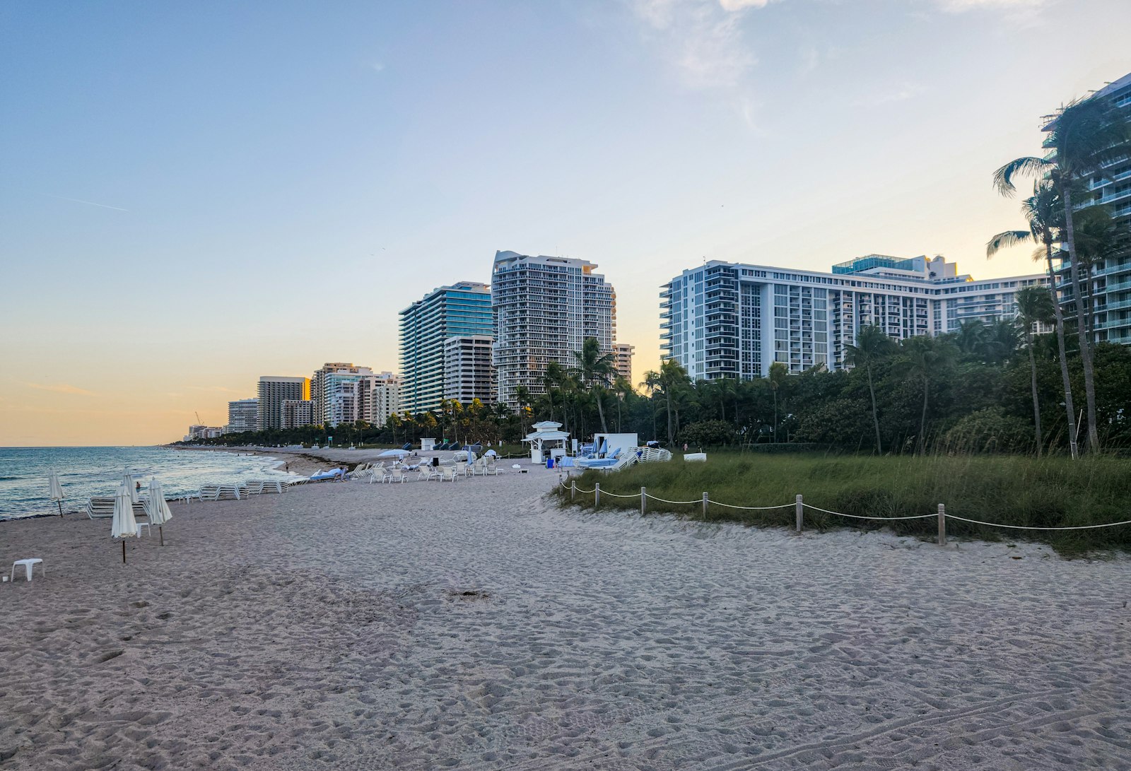 A sandy beach with buildings in the background